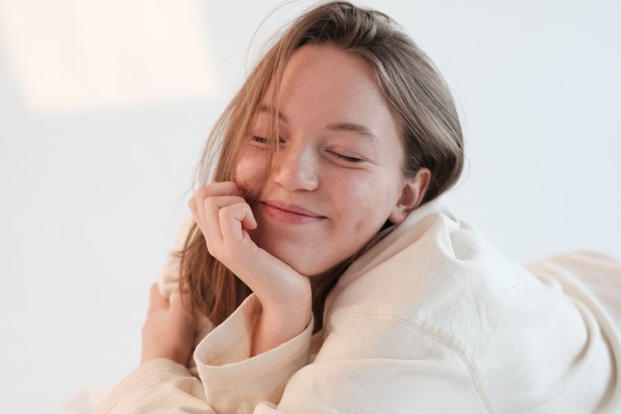 smiling girl practicing self-care tips for college students 