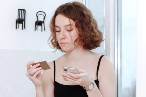 11 Toxic Habits You Need To Discard Right Now woman on phone indulging in toxic habits