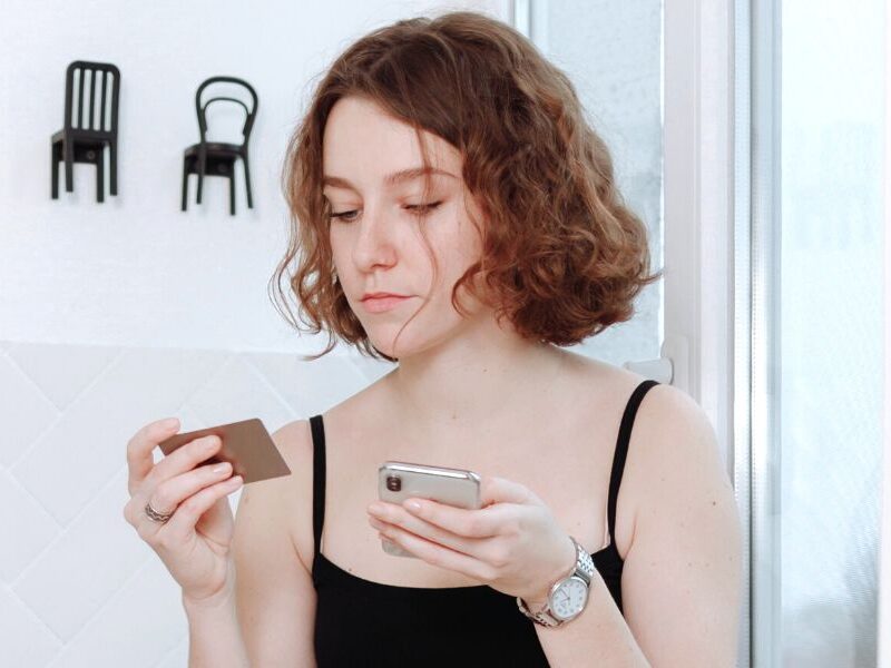 woman on phone indulging in toxic habits