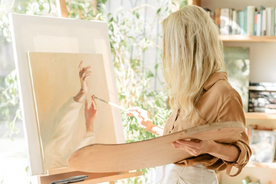 woman painting a picture after learning how to create the life of your dreams