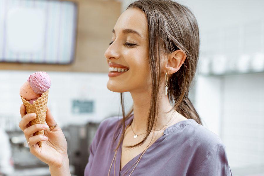 woman smiling at an ice cream cone