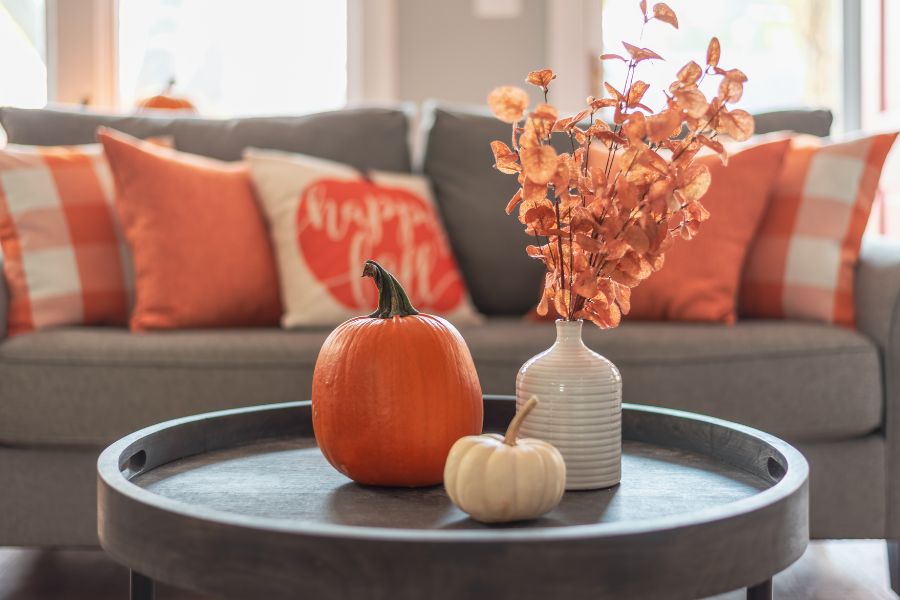 pumkin decor and leaves vase on table