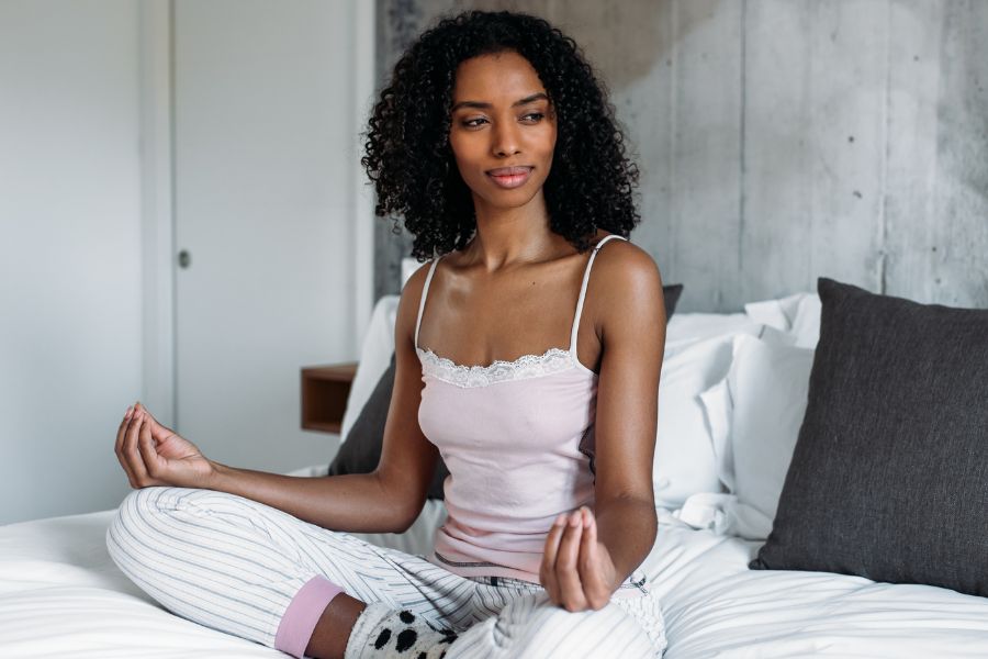 woman smiling in yoga position while staring at something