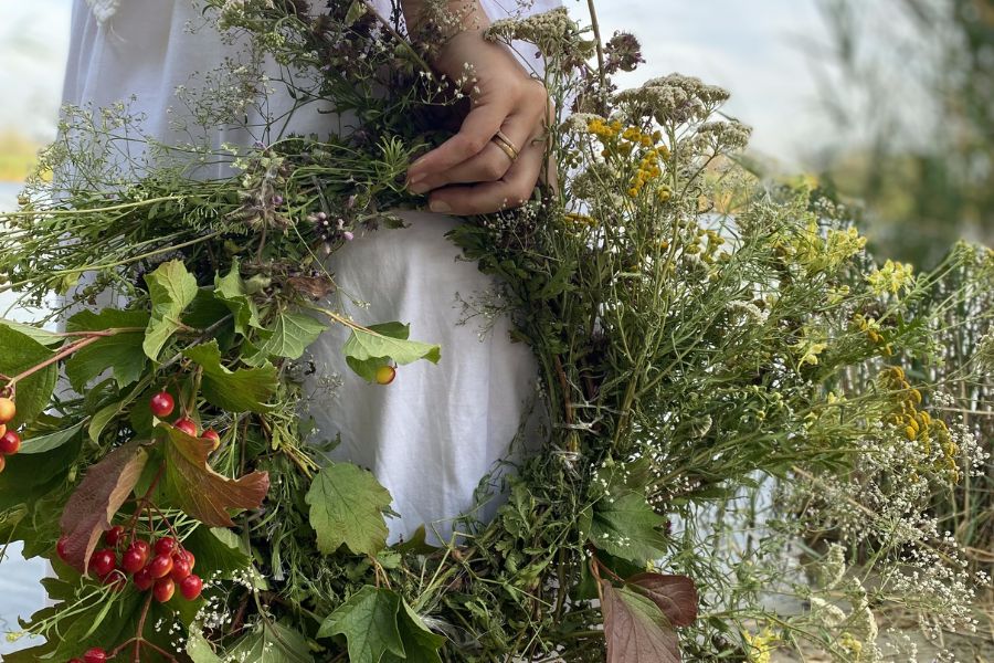 woman carrying spring wreath