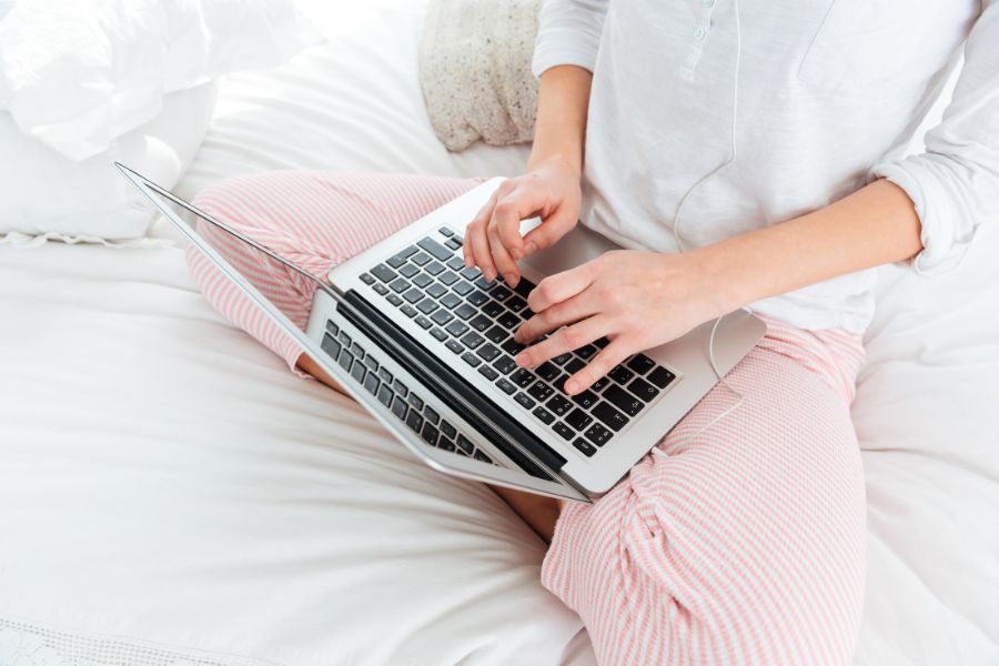 working on laptop in bed 