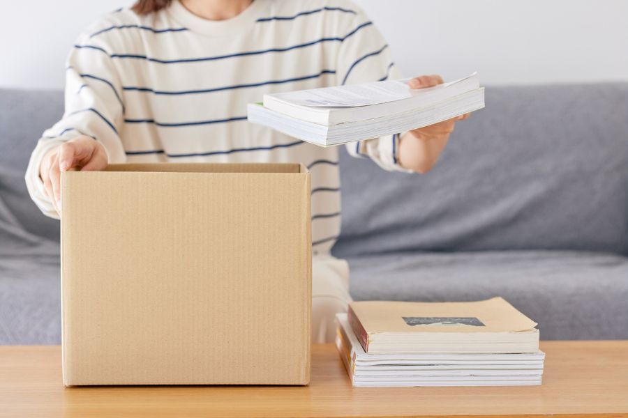 putting books in a cardboad box