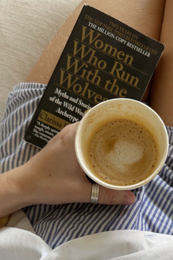'women who run with the wolves' in lap with coffee