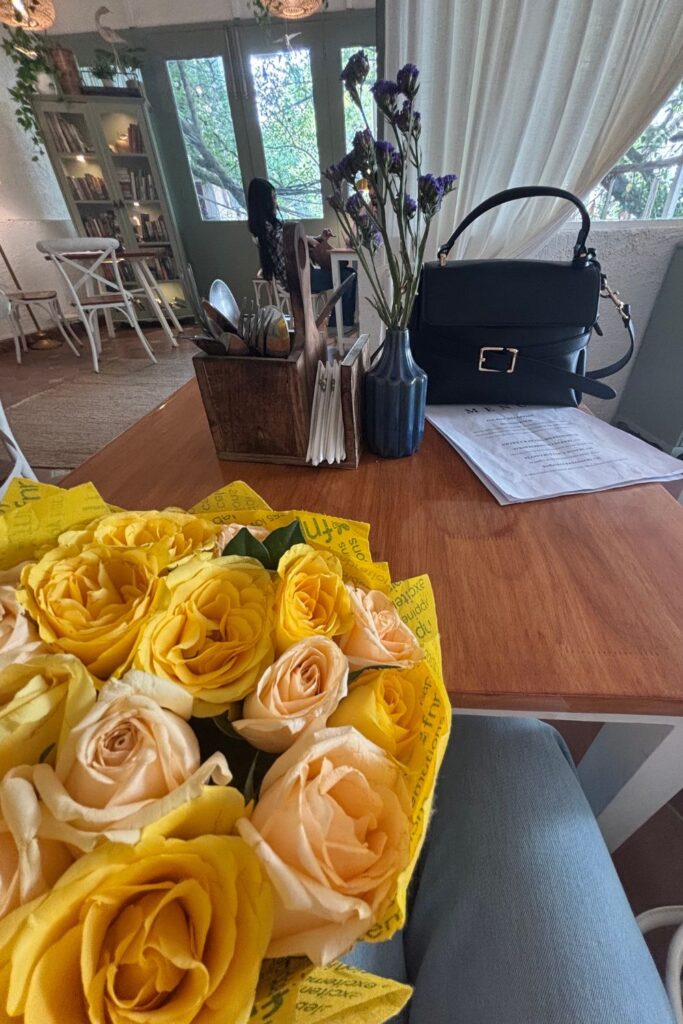solo date with yellow flowers at a coffee shop