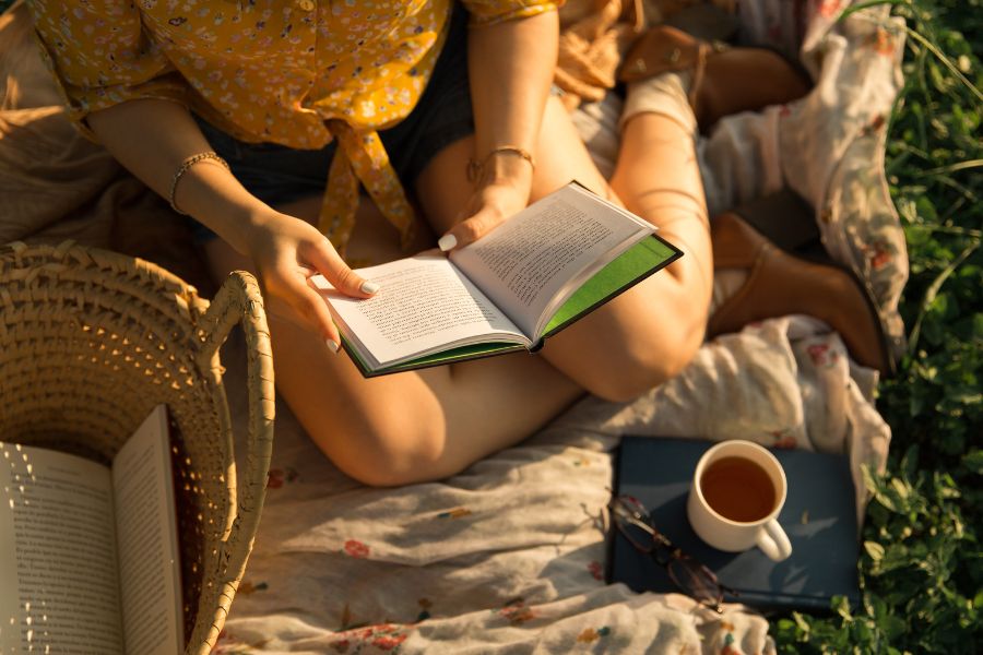 reading outside in sun with tea