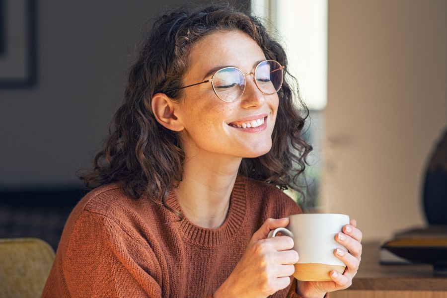 woman enjoying tea with eyes closed