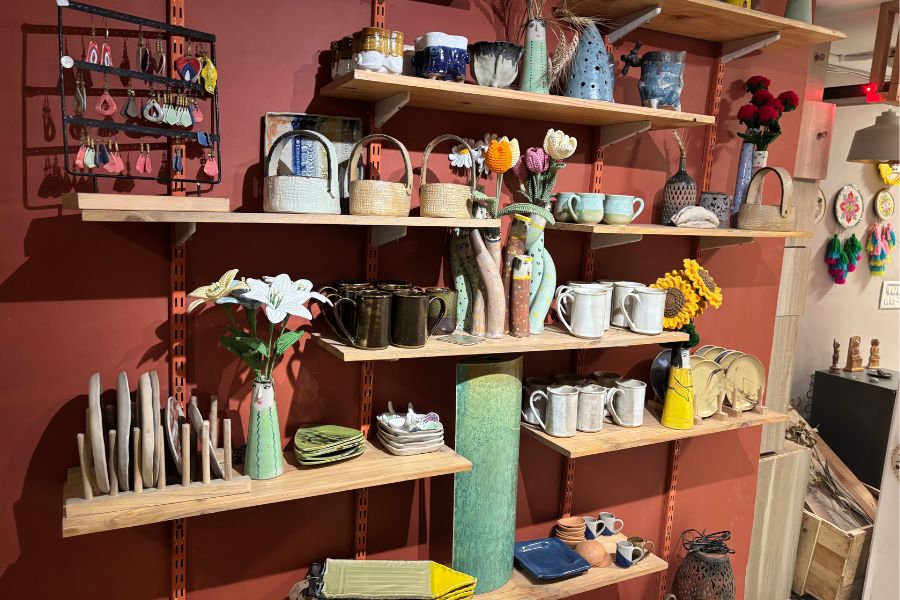 pottery and ceramic collection on shelves in a pottery class