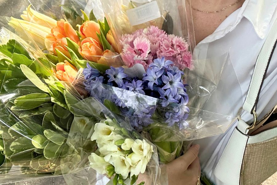 holding colourful bouquet in hand