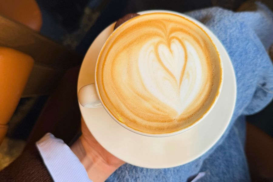 hand holding coffee mug in lap