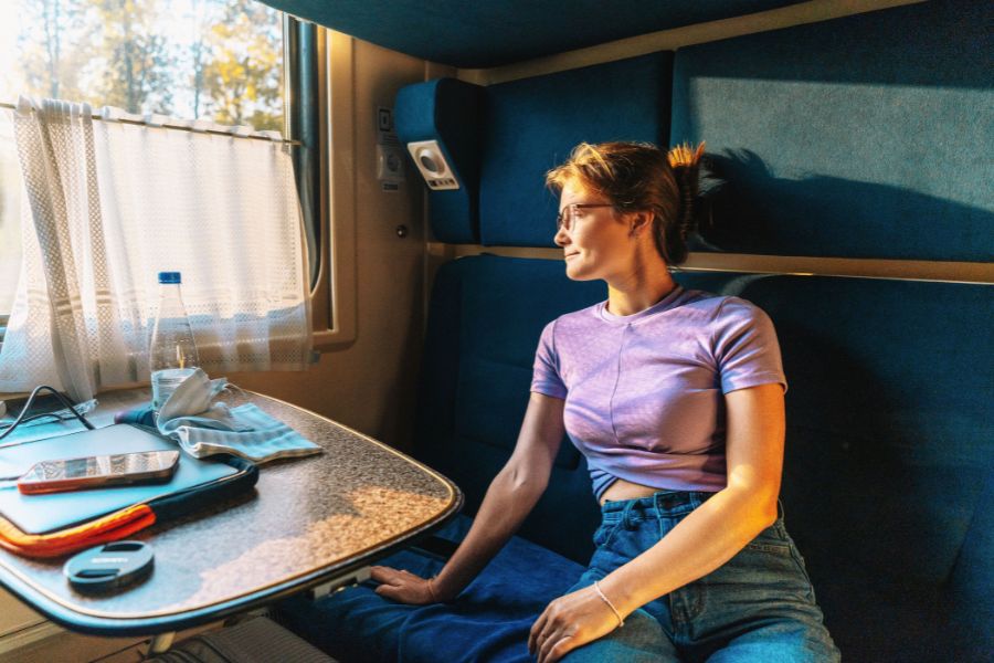 woman staring out window in a train