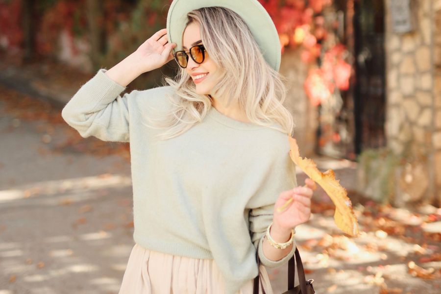 woman posing in blue sweatshirt and matching hat